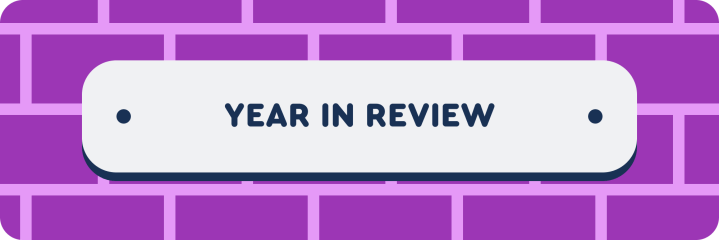 Banner with the text 'Year in Review' on a white rounded rectangle, set against a purple brick wall background.